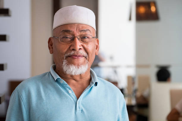 a portrait of a senior malaysian man at home